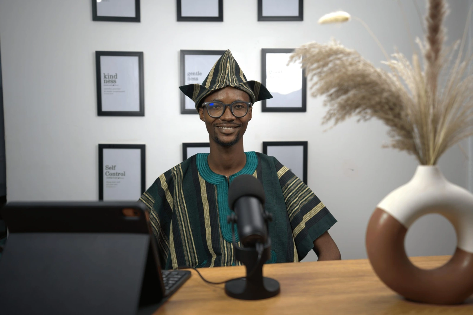 Ajíbọ́lá Ọládìípọ̀ in traditional attire at his desk in Ibadan