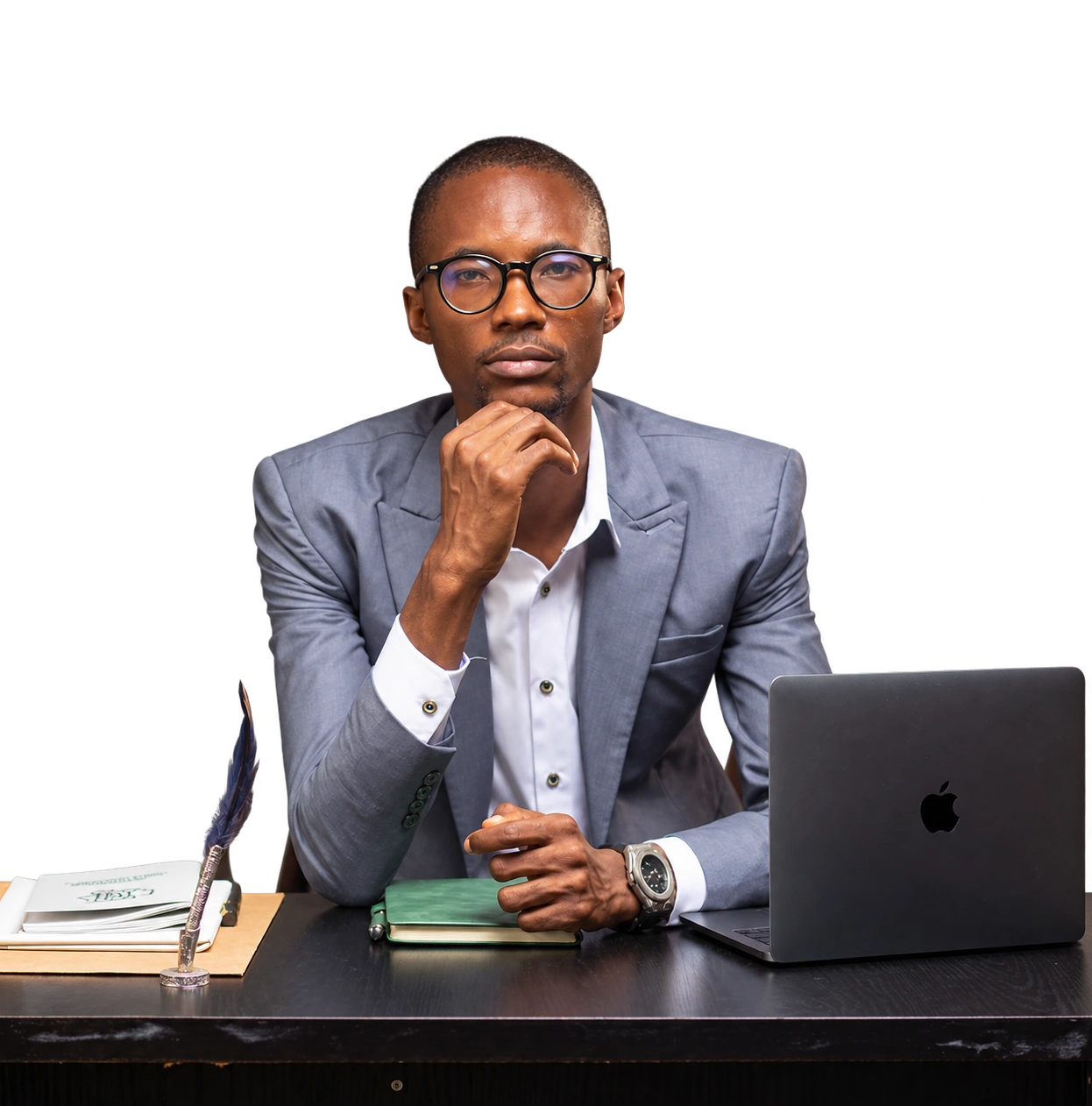 Ajíbọ́lá Ọládìípọ̀ at his desk with a notebook and laptop